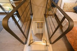 a stairway leading up to a room with a bed at Casa Iolanda II in Corfu