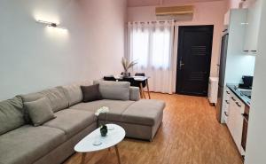 a living room with a couch and a table at PG Luxury Apartment in Kavála