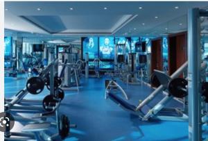 a gym with several tread machines in a room at Roda Golf & Beach Resort, Murcia in Roda