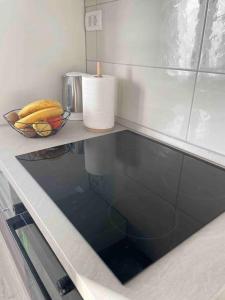 a counter top with a bowl of bananas on it at Apartman Toni in Skradin
