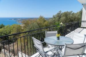 a balcony with a table and chairs and the ocean at Come and Sea apartment in Vlachata