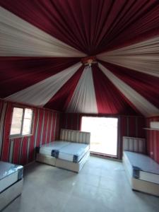 a room with two beds in a tent at Wadi rum Sunrise luxury camp in Wadi Rum