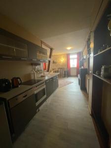 a kitchen with a large kitchen with counters and cabinets at Landhotel Peters in Canow