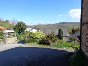 an empty road in a village with houses at Staylittle Farm in Dolgellau