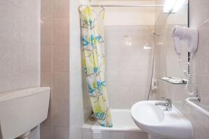 a bathroom with a sink and a shower curtain at Santa Barbara by Umbral in Fátima