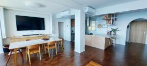 a kitchen and dining room with a table and a tv at COBAR0108 - Edifício Oceania in Salvador