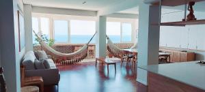 a living room with hammocks in a house with the ocean at COBAR0108 - Edifício Oceania in Salvador