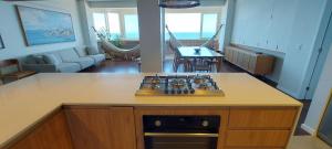 a kitchen with a stove and a counter top at COBAR0108 - Edifício Oceania in Salvador