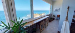 a room with a large window with a view of the ocean at COBAR0108 - Edifício Oceania in Salvador
