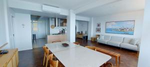 a kitchen and living room with a table and chairs at COBAR0108 - Edifício Oceania in Salvador