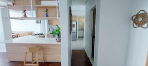 a kitchen with white counters and a white counter top at COBAR0108 - Edifício Oceania in Salvador