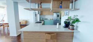 a kitchen with a white counter top in a room at COBAR0108 - Edifício Oceania in Salvador