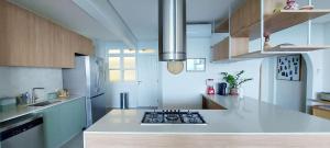 a kitchen with a white counter top with a stove at COBAR0108 - Edifício Oceania in Salvador
