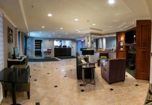 a living room with a couch and chairs and a table at La Quinta by Wyndham Milwaukee Delafield in Delafield
