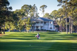a woman is playing golf on a green at Inn and Club at Harbour Town in Hilton Head Island