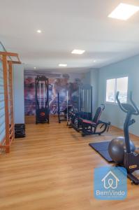 a gym with treadmills and exercise equipment in a room at Studio Completo a 150m da Praia de Piatã 2 in Salvador