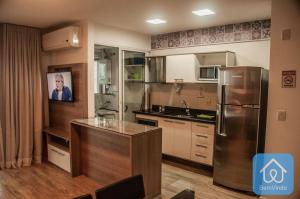 a kitchen with a stainless steel refrigerator and a counter at Apartamento completo ao lado do Salvador Shopping in Salvador