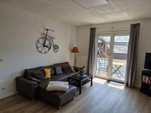 ein Wohnzimmer mit Sofa und Fahrrad an der Wand in der Unterkunft Ferienhaus SteigRhein in Filsen
