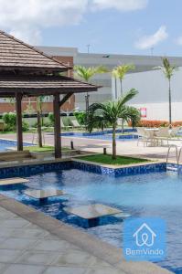 a swimming pool at a resort with a gazebo at Apartamento ao lado do Salvador Shopping 3 in Salvador