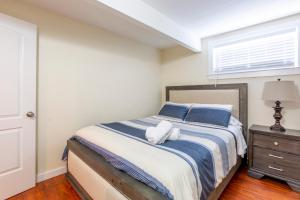 um quarto com uma cama com almofadas azuis e uma janela em @ Marbella Lane - 2BR Cozy LwrLvl in DTWN SJ em San José