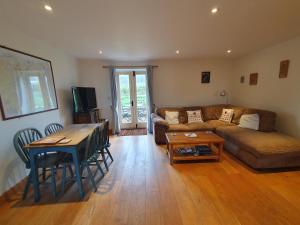 a living room with a couch and a table at Swallows Rest in Hexham