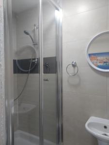 y baño con ducha, lavabo y espejo. en Sea View Large Valletta Appartment en La Valeta