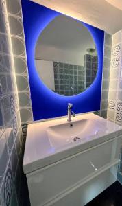 uma casa de banho com um lavatório branco e um espelho. em Ô perché em Toulon