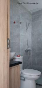 a bathroom with a toilet and a sink and a shower at Thien An Pine Hill Homestay Hue in Hue +79 photos