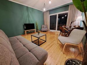 a living room with a couch and a table at Billie's guest house in Iraklitsa