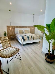 a bedroom with a bed and a chair at White Sand Apartments Downtown Albufeira in Albufeira