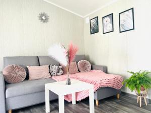 a living room with a couch and a table at Holiday Camp Sarbinowo in Sarbinowo