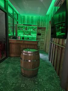 a bar with a wooden barrel in the middle of a room at Lamarck Guest in Bourges