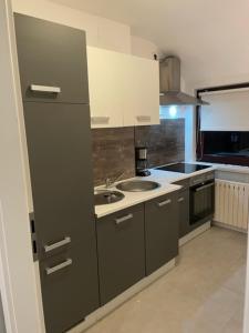 a small kitchen with a sink and a stove at City Apartment Bremen in Bremen