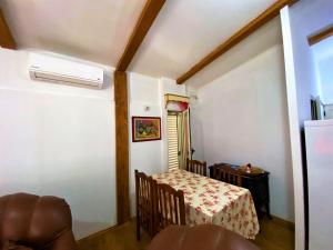a small room with a table and a table and chairs at Ramo's Green Beachside Retreat - Cozy 2 Bedroom Home in Vlorë