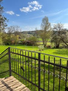 a fence with a view of a field at Villa Beata in Radvánovice