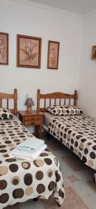 two beds sitting next to each other in a room at Villas Del Mar 2-bedroom Apartment with Swimming pool in Torrevieja