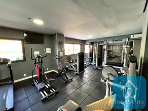 a gym with several treadmills and machines in it at Apartamento com linda vista mar no Bahia Suites in Salvador
