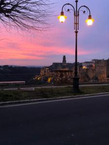 a street light on the side of a road at sunset at Il Girasole Storico in Pitigliano