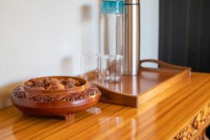 a bowl of nuts sitting on a wooden table at Indus Riverside Homestay- Spituk in Pituk