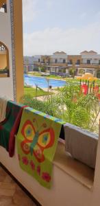a view of a pool from the balcony of a resort at SALICORNE 1 marina saidia appt in Saïdia