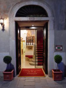 a door to a store with a red rug in front at Hotel Corte dei Greci in Venice