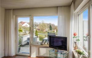 a living room with a tv and a large window at Beautiful Apartment In Detmold With Wifi And 1 Bedrooms in Detmold