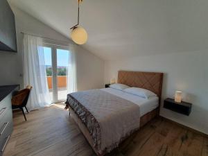 une chambre avec un lit et une grande fenêtre dans l'établissement Apartman Rio de Mar, à Bibinje 36 autres photos