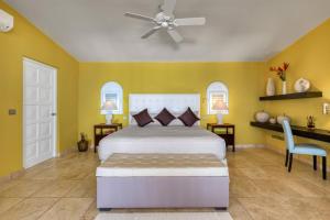 a bedroom with a bed and a ceiling fan at Villa La Vie en Bleu in Marigot +30 photos