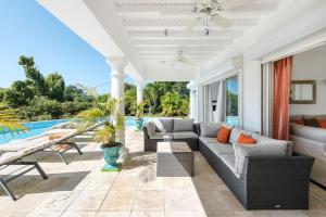 a living room with a couch and a pool at Villa Lune de Miel in Marigot
