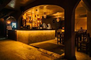 a restaurant with a bar in a dark room at baXar in Pie de la Cuesta