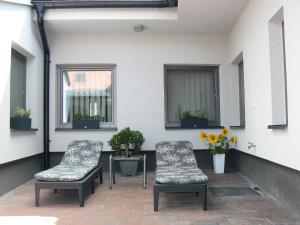 two chairs and a table on a patio at Ubytování U Jany in Zaječí