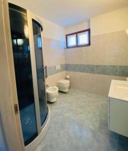 a bathroom with a shower and a toilet and a sink at Casa Azalea in Colico +11 photos