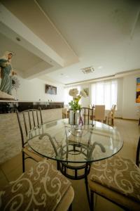 a dining room with a glass table and chairs at Pansion Milena i Mario in Međugorje