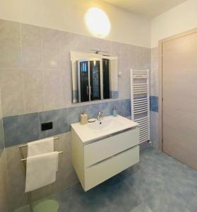 a bathroom with a white sink and a mirror at Casa Azalea in Colico